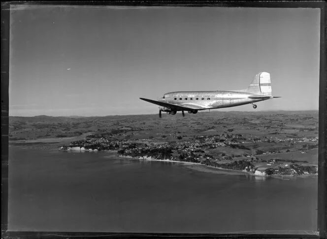 New Zealand National Airways Corporation (NAC) Flagship Dakota aircraft in flight over Auckland