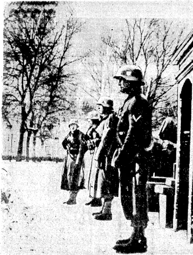 Sport and General" Photo. German. soldiers on guard at Trondheim after the invasion of Norway last month, and right, one of the invaders posting a proclamation in a street of Oslo, the Norwegian capital. (Evening Post, 04 May 1940)