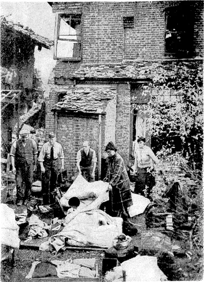 A member of the Royal Air Fore c arrived home on leave to find his house had been bombed, so he sets to work to salvage a jew belongings. (Evening Post, 09 November 1940)