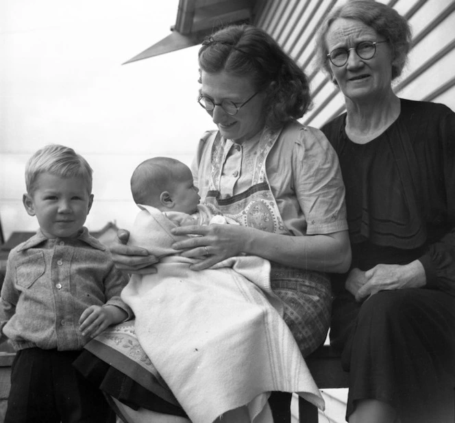 A family from Kumara, Westland, including a young boy, a woman holding a baby and an older woman