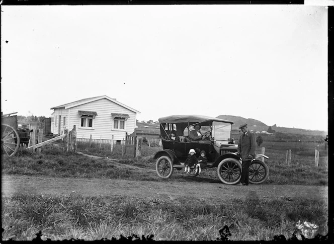 Model T Ford outside a farm house