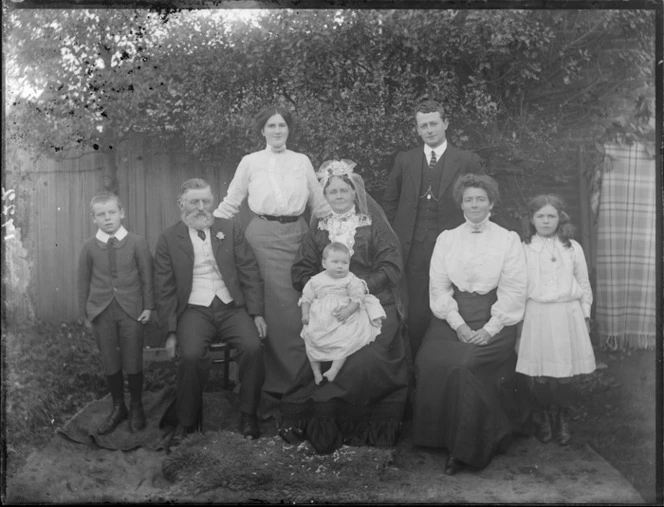Wedding group, showing unidentified men, women and children, including an elderly bride and groom, in a garden, possibly Christchurch district