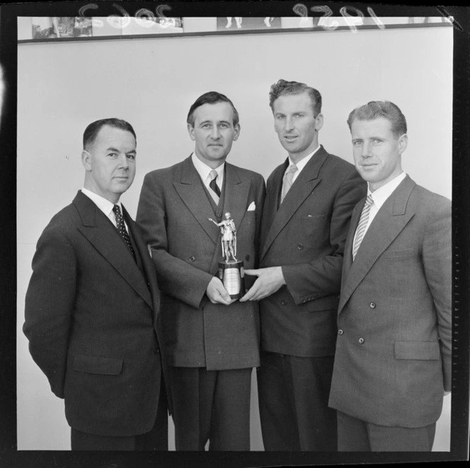 Members of the Wellington 22 Club debating team, which beat the Auckland team, with trophy