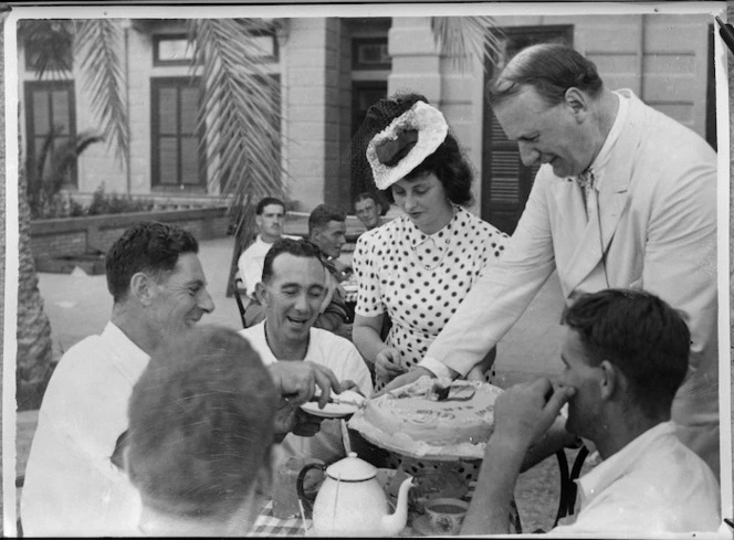 NZ convalescents receiving cake from Sir Miles Lampson at opening of Kiwi Club, Helwan