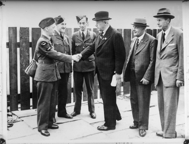 New Zealand Prime Minister Peter Fraser touring the bombed areas of Manchester meets three RAF New Zealanders on leave