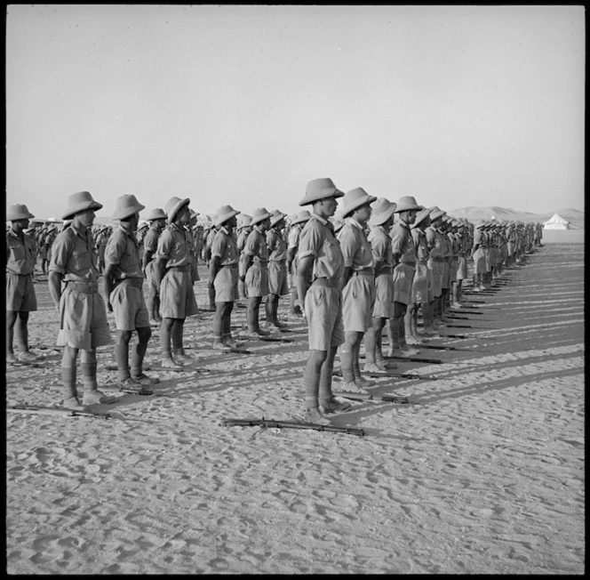 Members of Maori Battalion lined up watching concert party entertaining King of Greece, Helwan