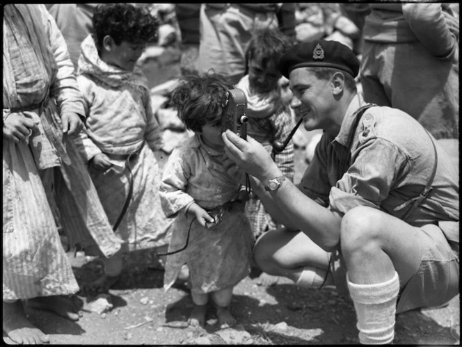 Son of Syrian tribal chief examines movie camera, World War II - Photograph taken by H Paton