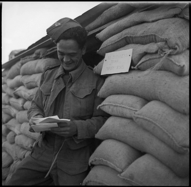 Maori soldier reading letters at Christmas in the Western Desert