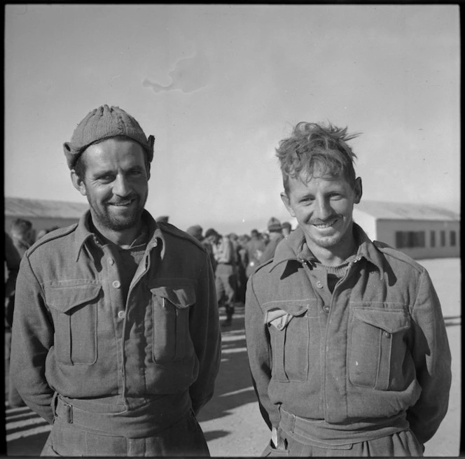 Privates B F Hooker and R E Riddle back at NZ Base Camp after imprisonment in Bardia, Libya - Photograph taken by M D Elias