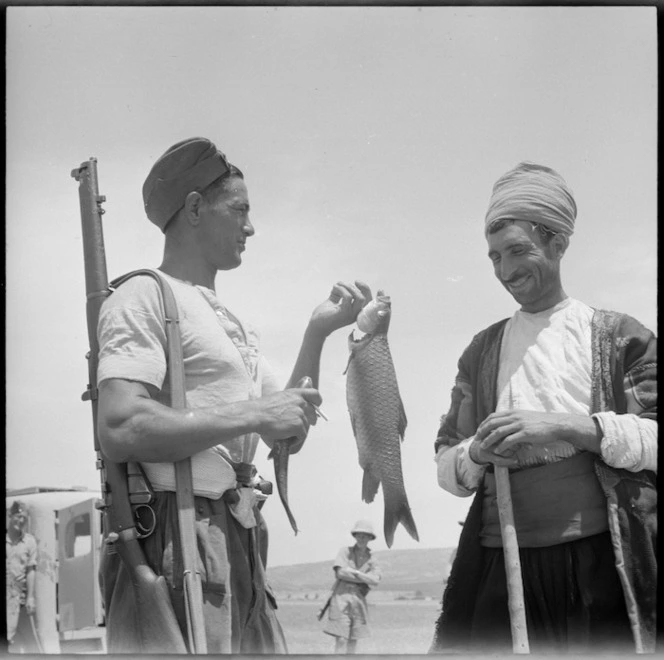 NZ soldier shows trout to Kurd near Syrian Turkish border, World War II - Photograph taken by M D Elias