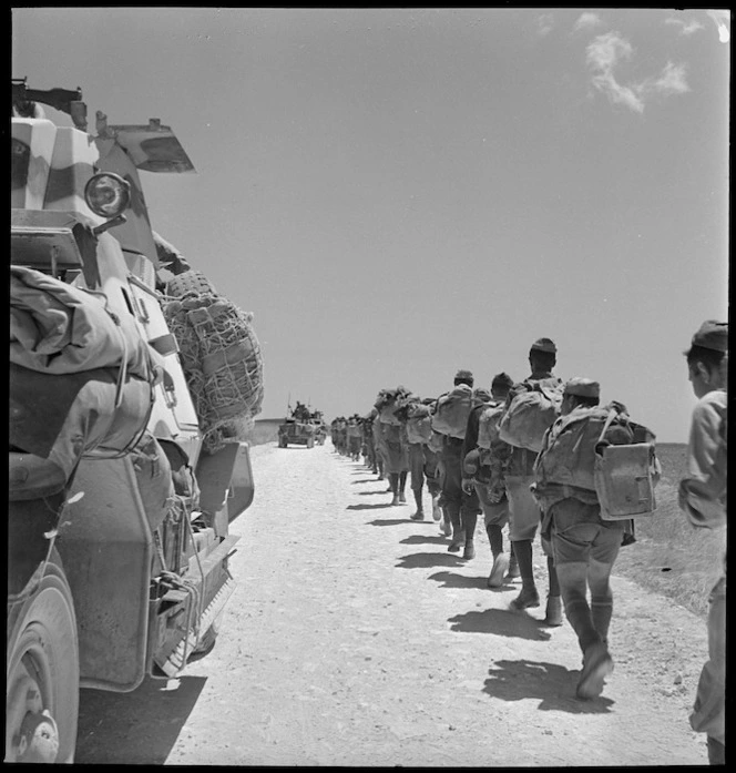 Armoured car passes Italian POWs marching back - Photograph taken by M D Elias