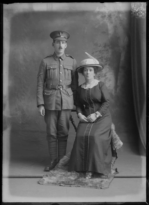 Studio portrait of unidentified soldier, in uniform and a woman, probably Christchurch district