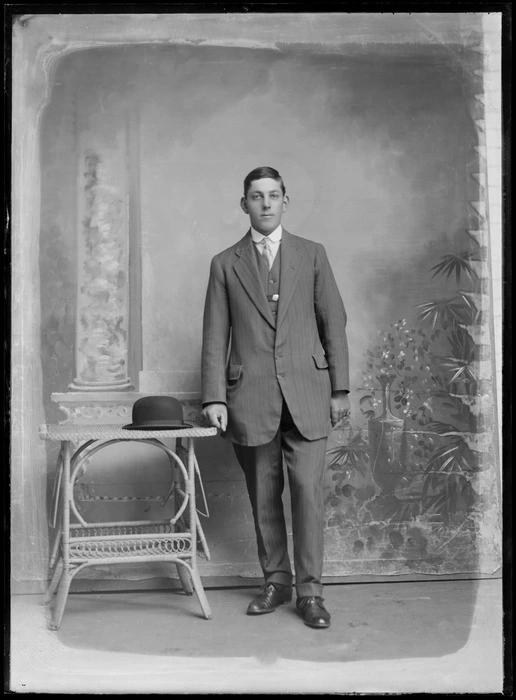 Studio unidentified portrait of a young man in a three piece striped suit, Arundel shit collar and striped tie standing, Christchurch