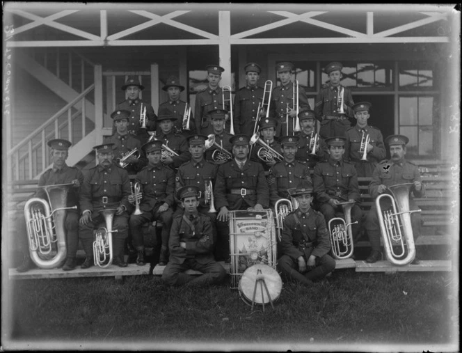 The New Zealand Army 9th Regimental Brass Band sitting in front of the barracks at casual camp, Hastings