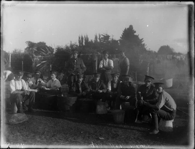 A group of unidentified soldiers peeling potatoes, at casual camp, Hastings