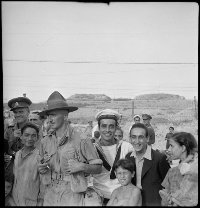 Lt Tremain and Pte Anning, members of the POW Sub Commission, among Italians on the Taranto waterfront, World War II - Photograph taken by W A Brodie