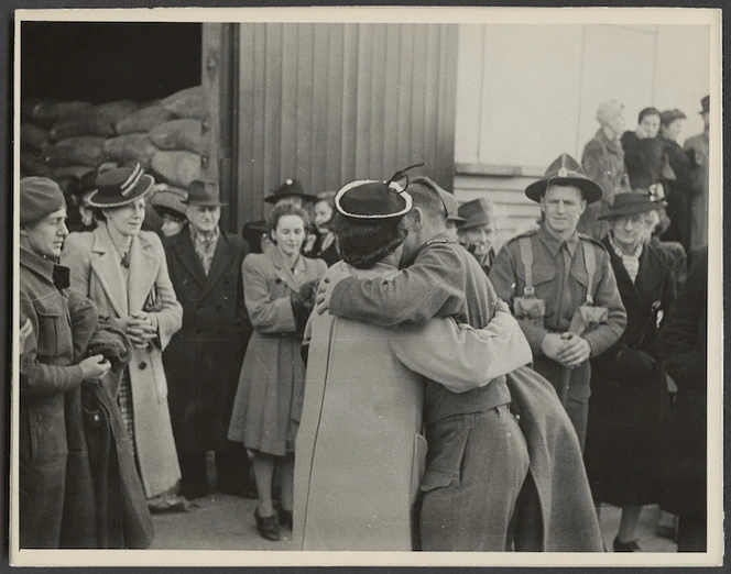 World War II servicemen being embraced after his return to Wellington on the hospital ship Wanganella - Photograph taken by Government Film Studios