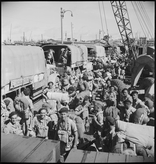 Men of 2 NZ Division sorting out their gear on Alexandria wharf in preparation for embarkation to Italy, World War II - Photograph taken by M D Elias