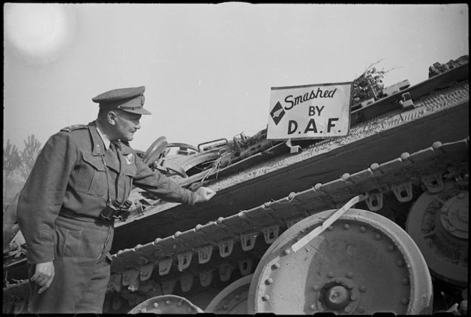 Lieutenant General Sir Bernard Freyberg beside notice 'Smashed by Desert Air Force' he placed on German tank, Italy - Photograph taken by G Kaye