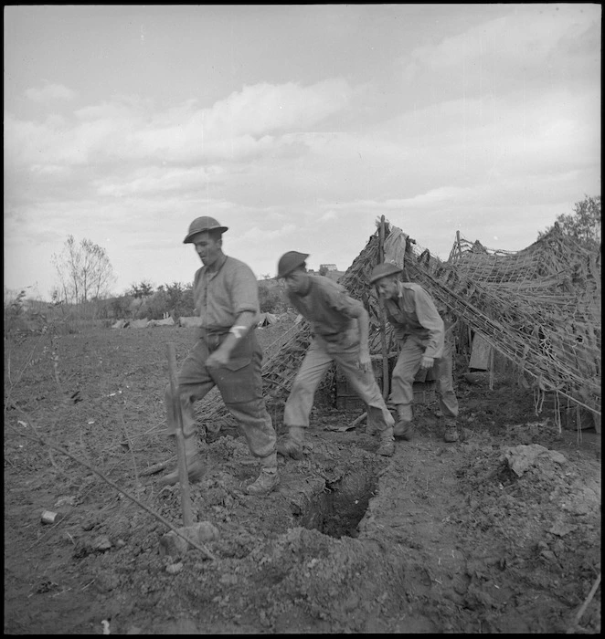 NZ gunners emerge from gunpit on the Sangro River front, Italy, World War II - Photograph taken by George Kaye