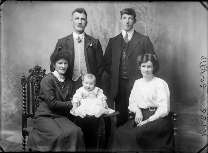Studio Corkill portrait family, parents and grandparents with grandchild in christening gown, Christchurch