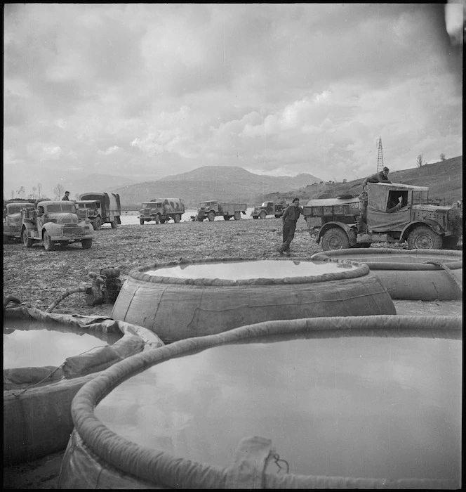 NZ Division water carts lined up on Sangro River bank in Italy, World War II - Photograph taken by George Kaye