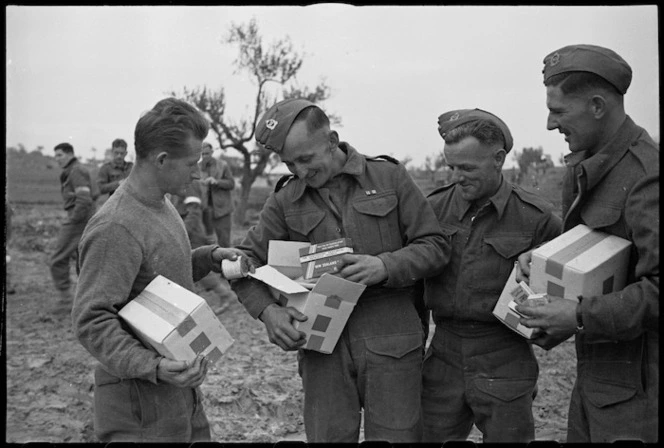 Men of 2 NZ Division on the Italian Front receive Patriotic Fund parcels a few days before Christmas, World War II - Photograph taken by George Kaye