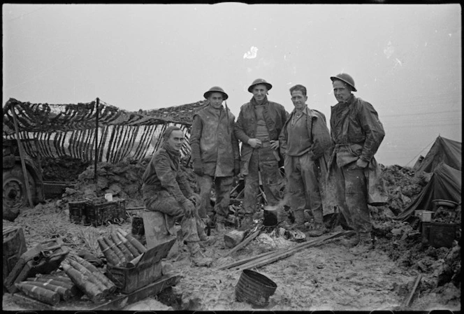 Men of New Zealand Artillery boil billy in wet and muddy surroundings on Christmas Eve afternoon, Italian Front, World War II - Photograph taken by George Kaye