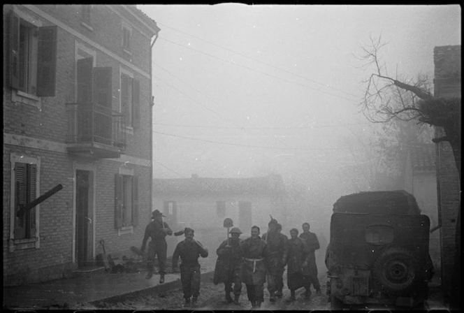 Winter conditions in an Italian village as NZ Division vehicles go forward, Italian Front, World War II - Photograph taken by George Kaye