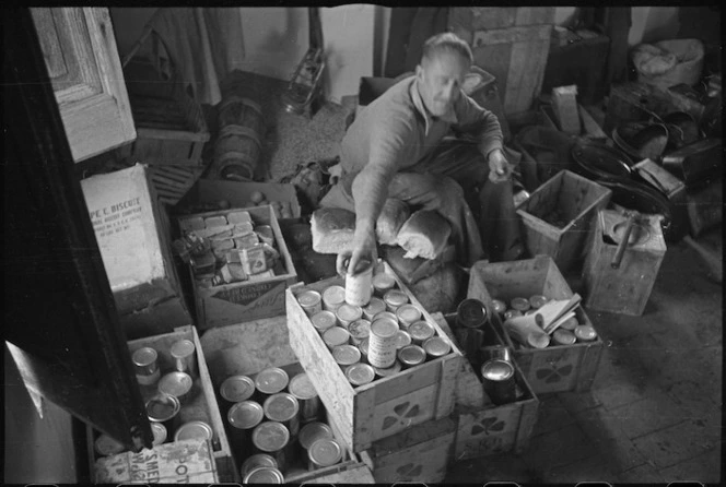 'Snow' Burton sorting out rations on the Italian Front, during World War II - Photograph taken by George Kaye