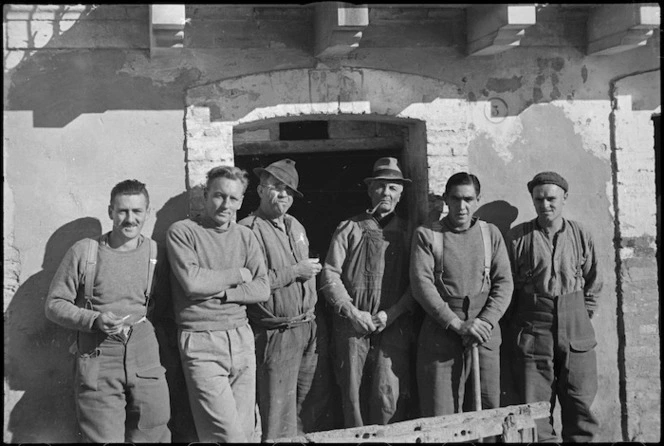 Two local residents with group of New Zealanders billetted in Italian village, World War II - Photograph taken by George Kaye