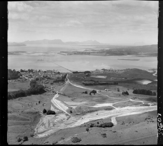 Portland Cement Works and residential village with jetty and railway on the inner Whangarei Harbour, with limestone quarry in foreground, Northland