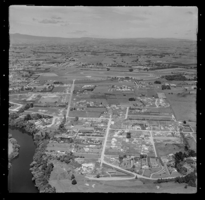 Hamilton City with Hamilton Golf Course and Braid Road with new housing development in foreground, with Te Rapa Racecourse beyond, Waikato Region