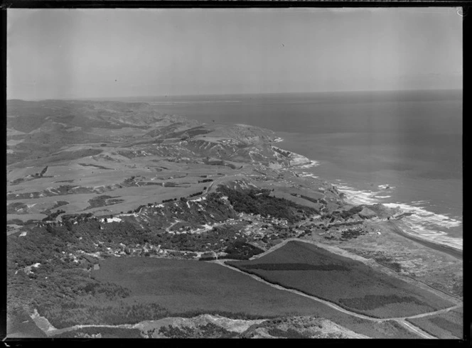 Muriwai Beach coastal settlement and pine plantation, farmland beyond, Auckland Region