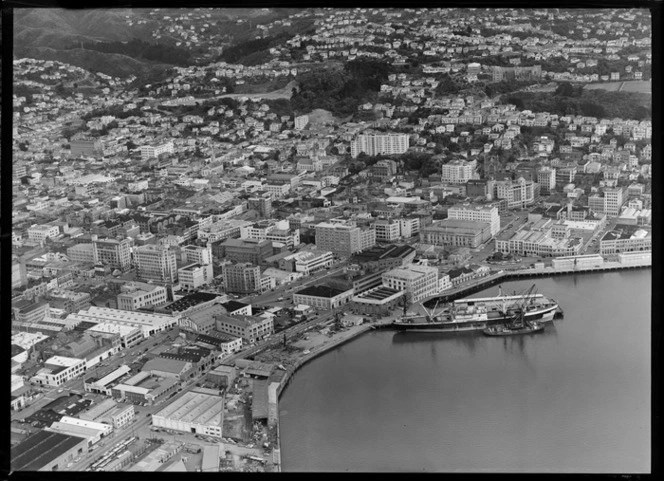 Wellington Harbour southern wharf area with Cable and Taranaki Streets and city, with Kelburn Park and Victoria University, Wellington City