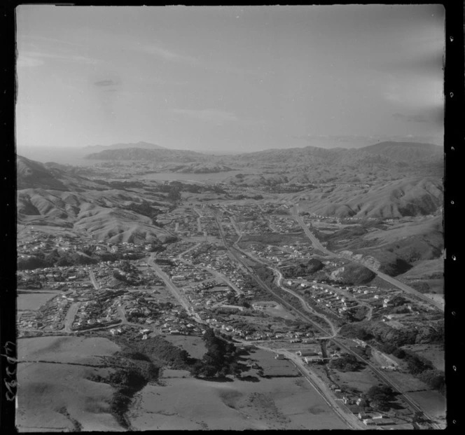 Tawa Flat with Lyndhurst Park, Tawa Township and Main Road, railway and Johnsonville-Porirua Motorway, looking north to Porirua Harbour, Wellington Region