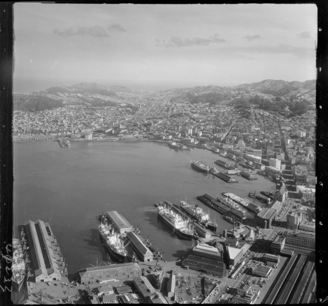 Wellington City Harbour with Customhouse and Waterloo Quay wharf areas in foreground to Te Aro Flat, Oriental Bay and Mount Victoria, looking south to Newtown beyond