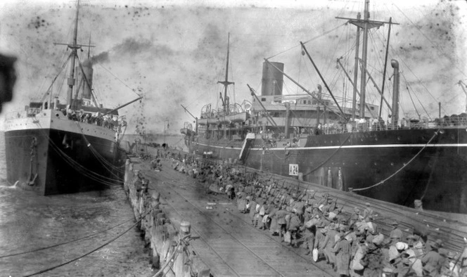 Ships alongside a wharf, and World War 1 troops