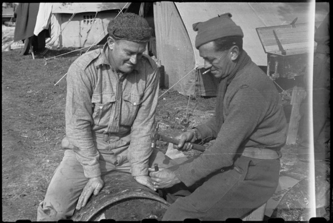 Gunner C S Land (Auckland) and Corporal G M Winlove making drum oven at their camp in Italy, World War II - Photograph taken by George Bull