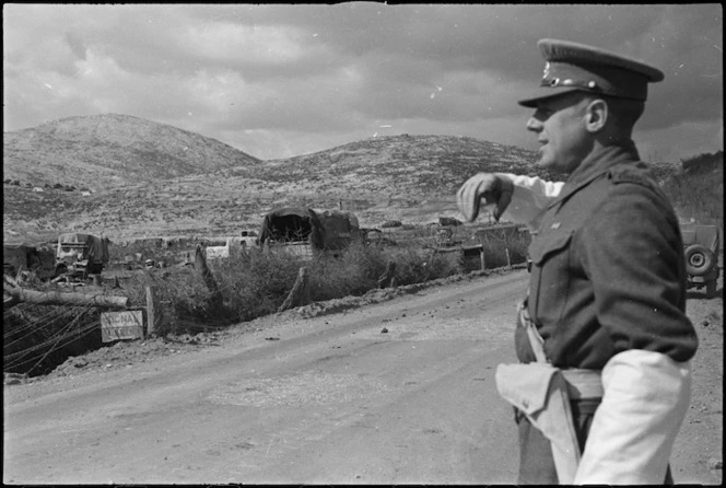 British MP directing traffic in forward areas of Monte Cassino Front, Italy, World War II - Photograph taken by George Kaye