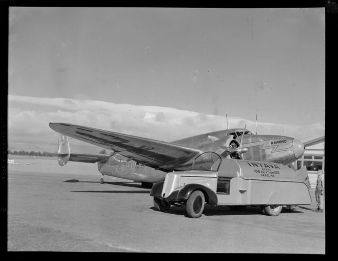 Lockheed Lodestar aeroplane 'Karoro' ZK-AHU, being refuelled by unidentified aircraft technicians, an an aerodrome, location unidentified