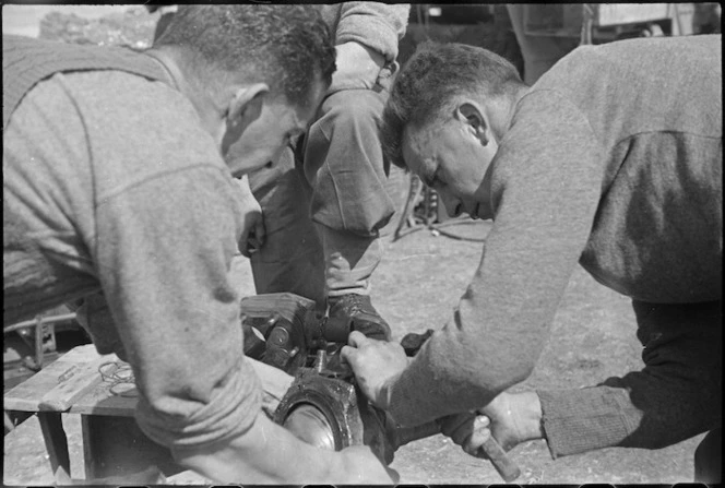 New Zealanders work on a motor near the Cassino Front in Italy, World War II - Photograph taken by George Kaye