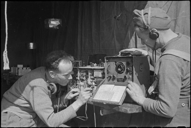 H L Willacy and I C Dalgety checking wireless sets on the Cassino Front in Italy, World War II - Photograph taken by George Kaye