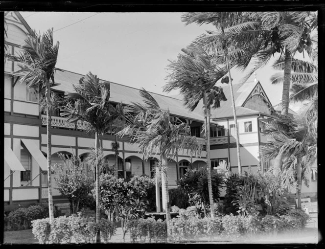 The three story wooden Casino Hotel with palm trees in front, Apia, Western Samoa