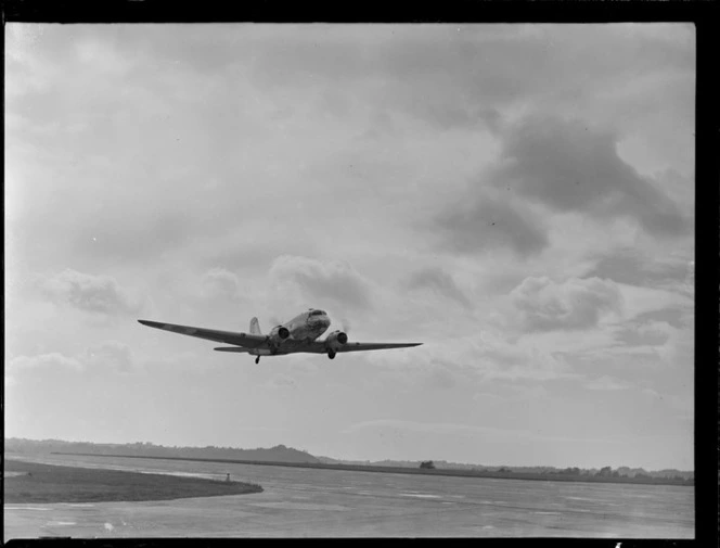 Douglas Dakota aeroplane taking off, [RNZAF Station, Whenuapai, Auckland?]