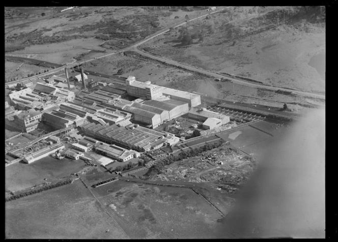 View of the Auckland Farmers' Freezing Works Southdown Factory with stock pens and railway line, Penrose, Auckland