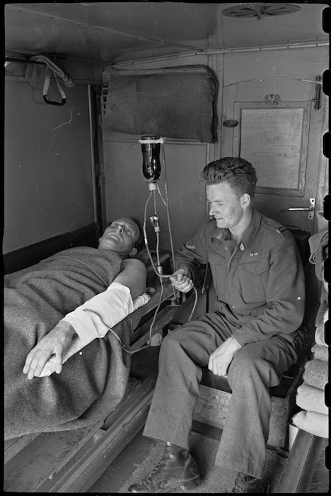 Blood transfusion apparatus for moving ambulances demonstrated by J R A Chote and R W E Taylor, Italy, World War II - Photograph taken by George Bull