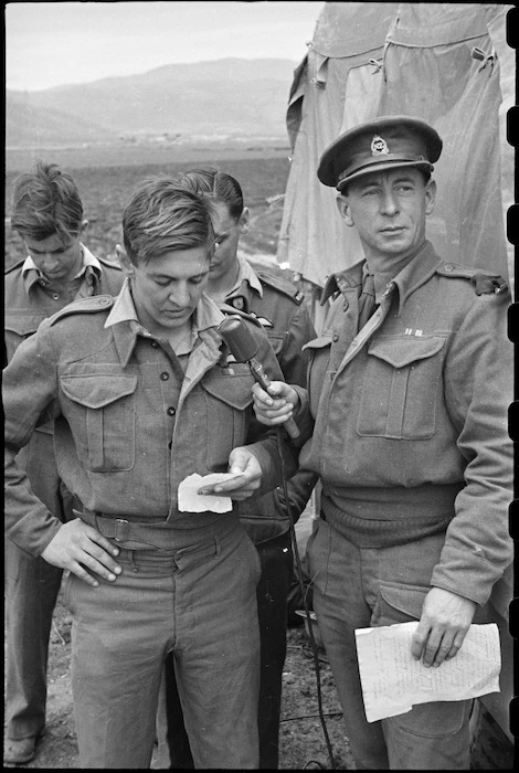 Flight Sergeant A G Newman records message to be broadcast in New Zealand from the Italian Front, World War II - Photograph taken by George Bull