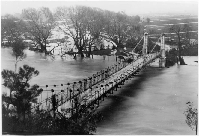 Suspension bridge over Hutt River floodwaters, Maoribank, Upper Hutt - Photograph taken by W Beavis