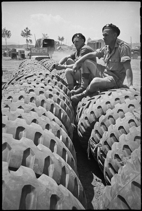 P T Hurren and G F McClure sit on large tyres close to forward areas of the Cassino Front, Italy, World War II - Photograph taken by George Kaye